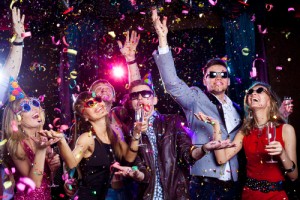Cheerful young people showered with confetti on a club party.  shutterstock_139152893